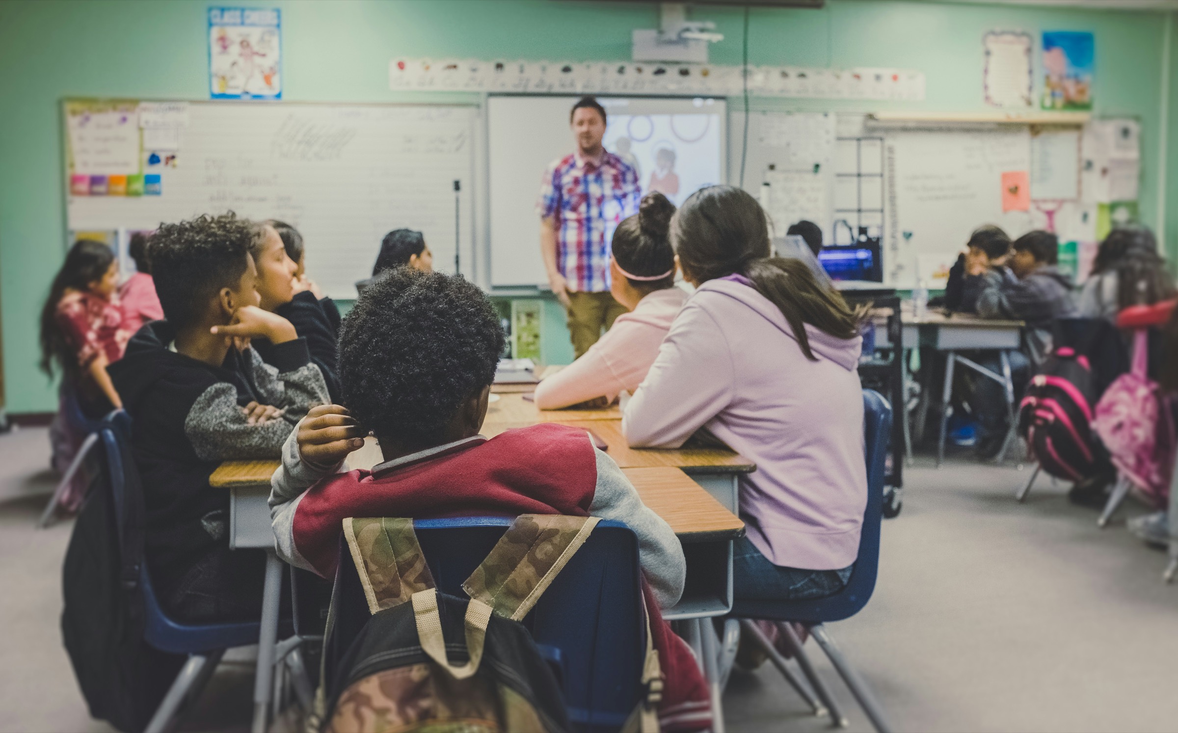 Pupils at their desks in a bright classroom